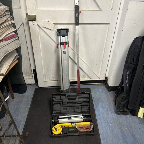 Surveying equipment kit with tripod and laser level.