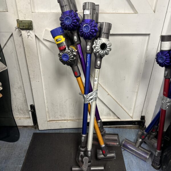 Lot of four Dyson cordless hoovers for spares and repairs.