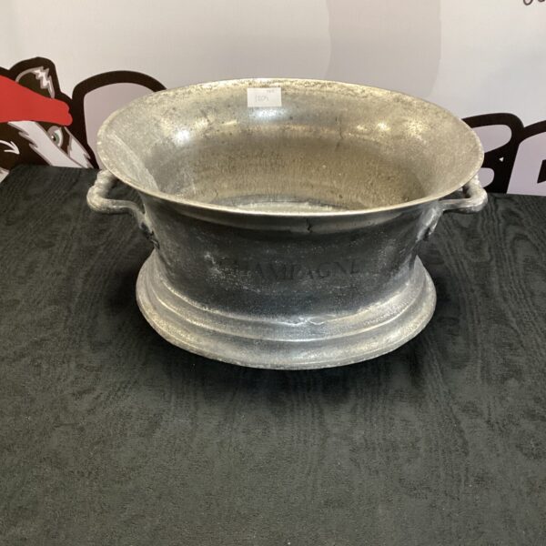 Vintage car wheel rim repurposed as a unique champagne bucket.