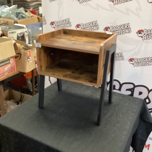 Rustic industrial bedside table with metal frame and wood drawer.