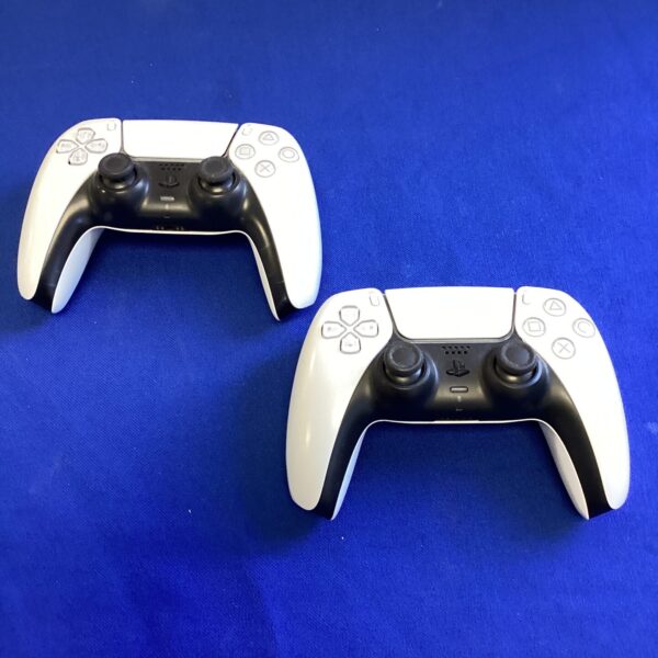 Two white and black PlayStation 5 DualSense controllers.