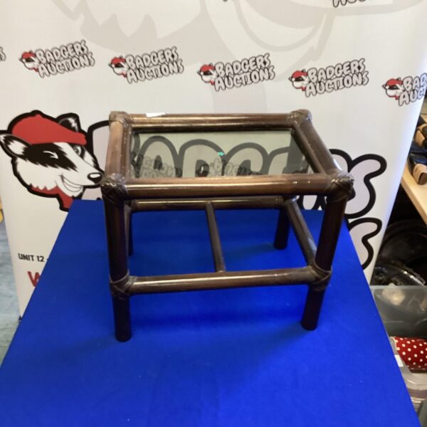 Small bamboo coffee table with a glass top for living room use.