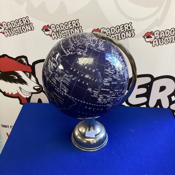 Vintage stainless steel globe with detailed world map.