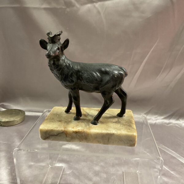 Vintage metal stag figurine on marble base, collectible sculpture.