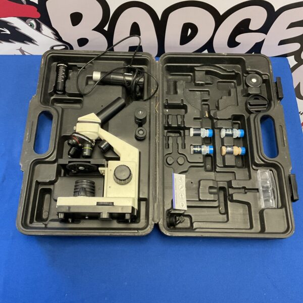 Vintage microscope in a hard case with accessories for collectors.