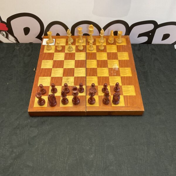 Vintage wooden chess set with classic pieces on a board.