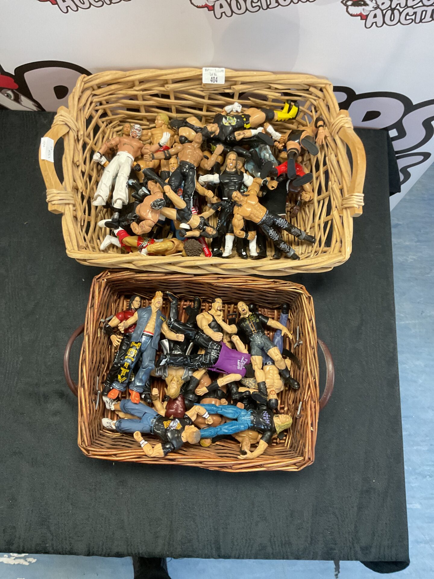 404 Two wicker baskets containing a selection of WWE figurines