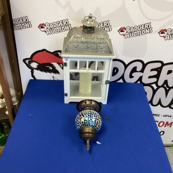 Intricate mosaic hanging candle lantern with colourful glass details.