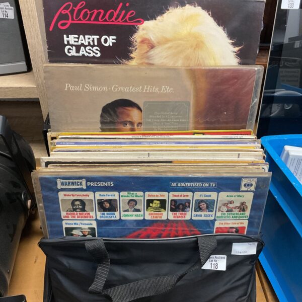 Collection of vinyl records including Blondie and Paul Simon albums.