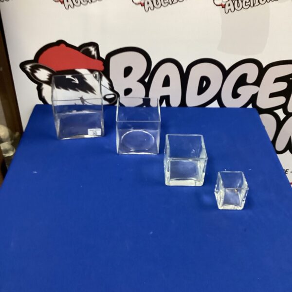 Set of three clear cube glass vases for modern decor.
