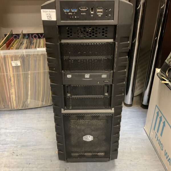 Black tower PC with Cooler Master branding and front panel connections.