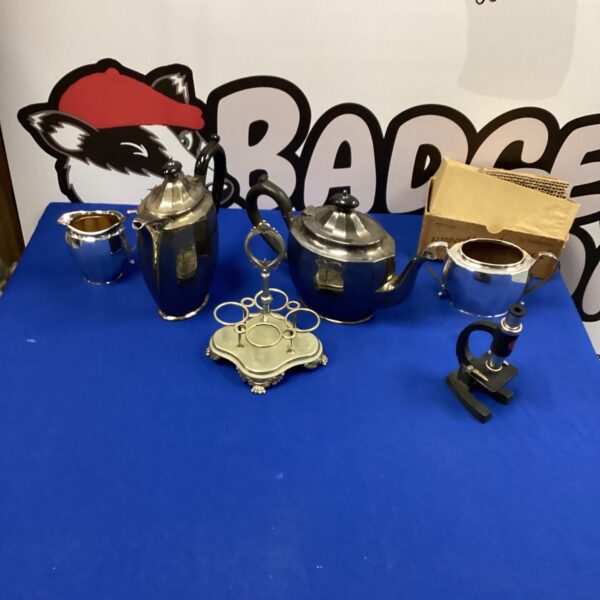Vintage silverplate coffee set displayed on a patterned tray.