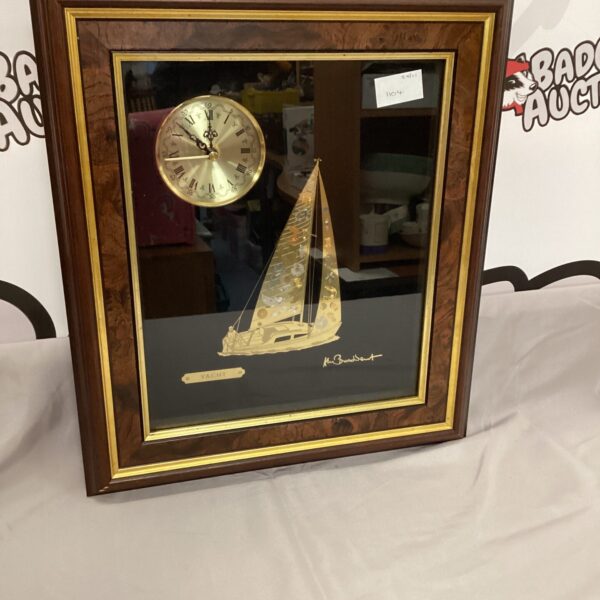Framed yacht wall clock with detailed nautical design.