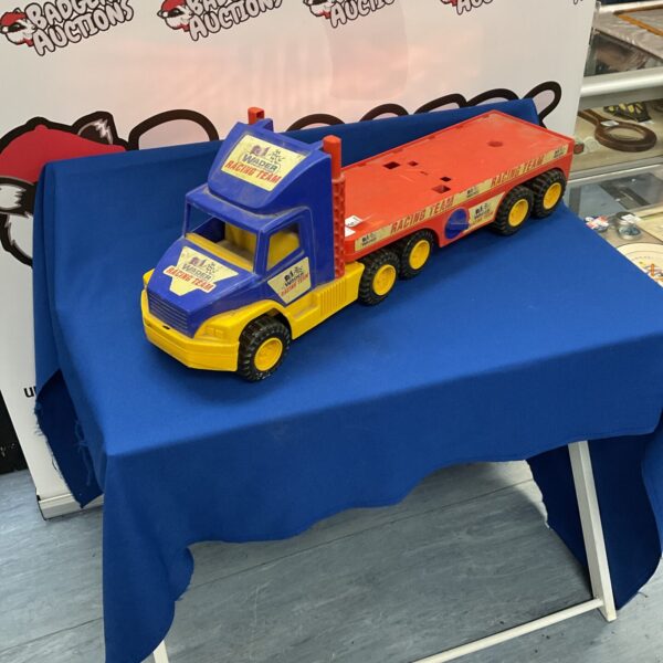 Vintage Wader racing team truck, red and yellow plastic toy.