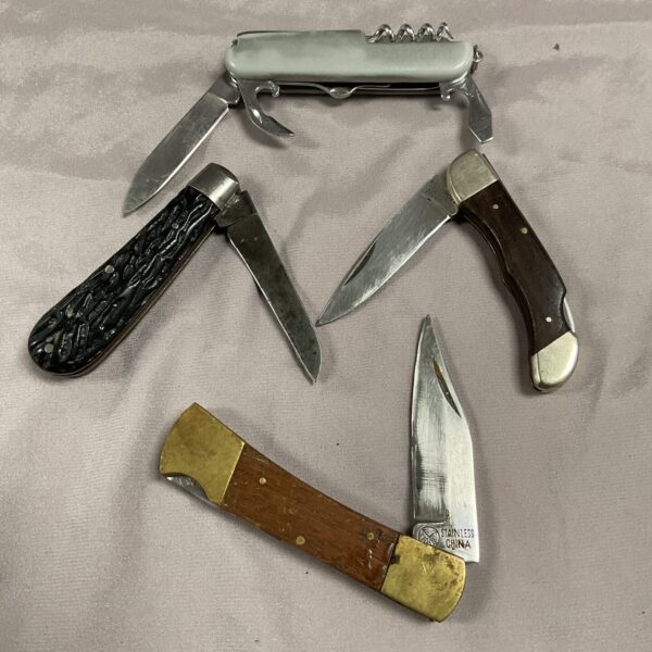 Lot of four vintage pocket knives with varied handles.