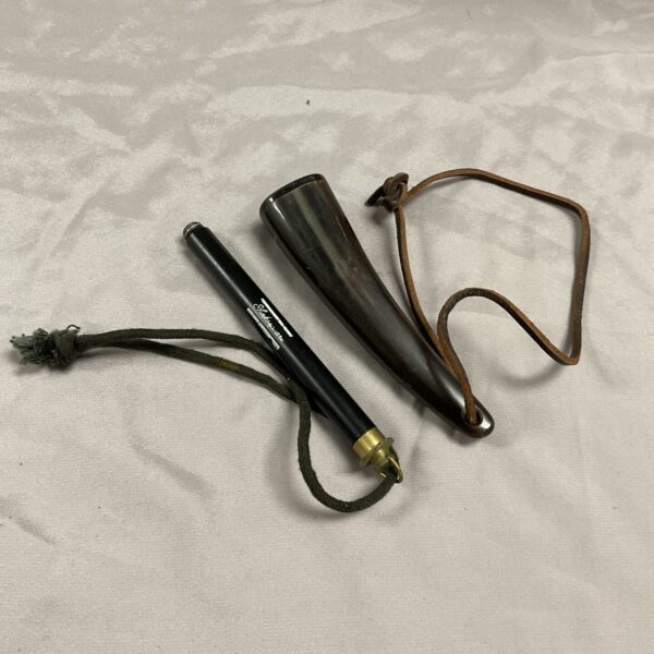 Antique horn fishing priest with woven cord, vintage angling tool.