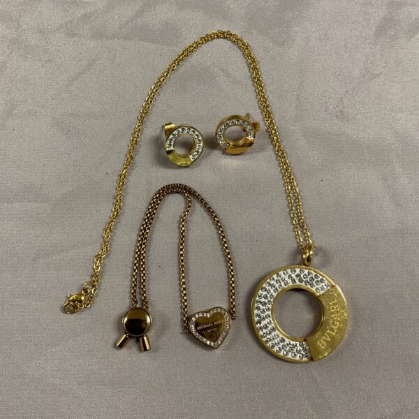 Bvlgari style necklace set with Michael Kors bracelet on display.