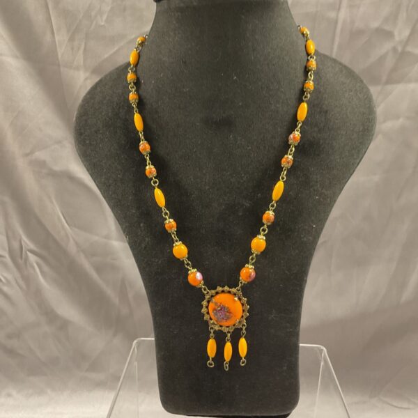 Vintage orange bead necklace with gold pendant, statement jewellery.