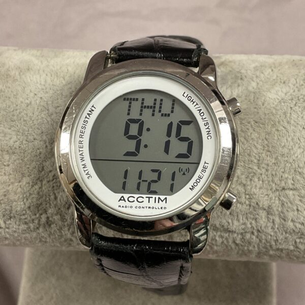 Black strap Acctim digital wristwatch displaying time and date.