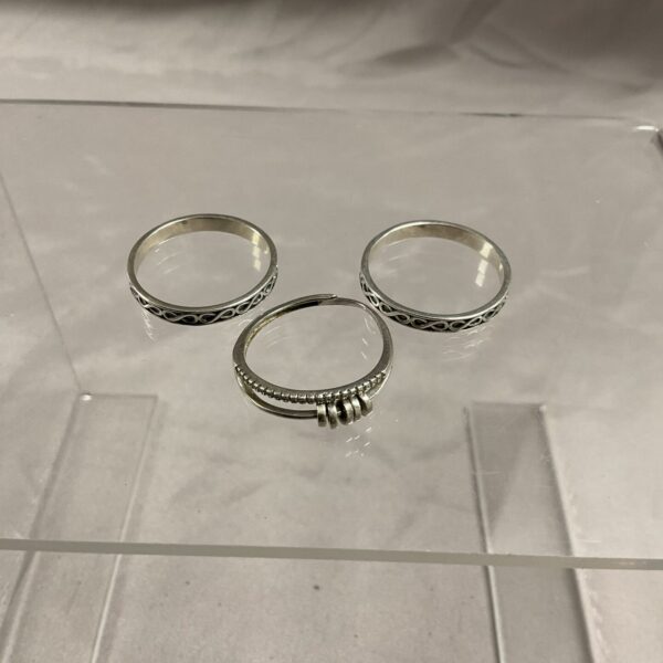 Trio of 925 silver rings in sizes U and W.
