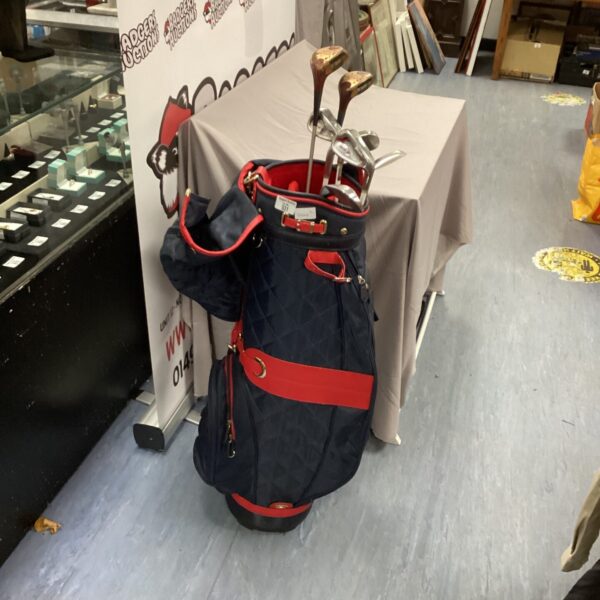 Ladies Srixon golf clubs with navy and red bag.