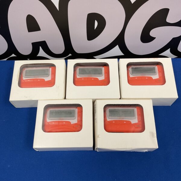 Lot of five vintage orange numeric pagers, retro tech collectible.
