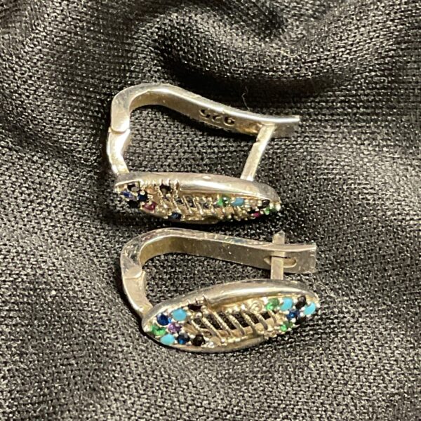 Vintage silver earrings with red and green stones.