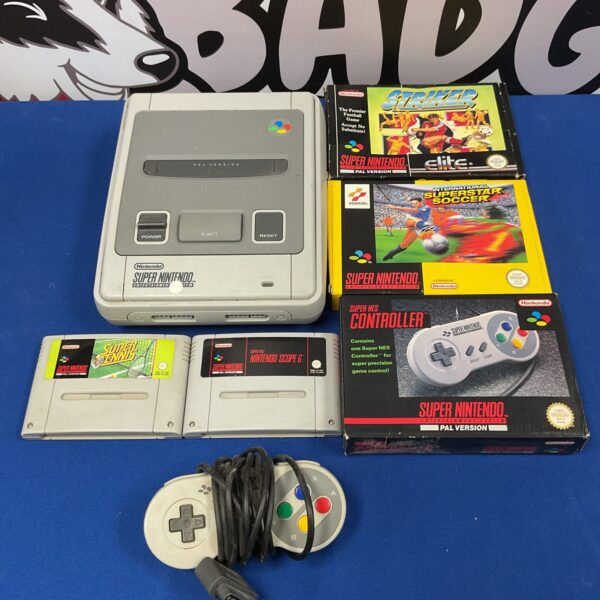 Super Nintendo SNES Console PAL version with controllers and games displayed.