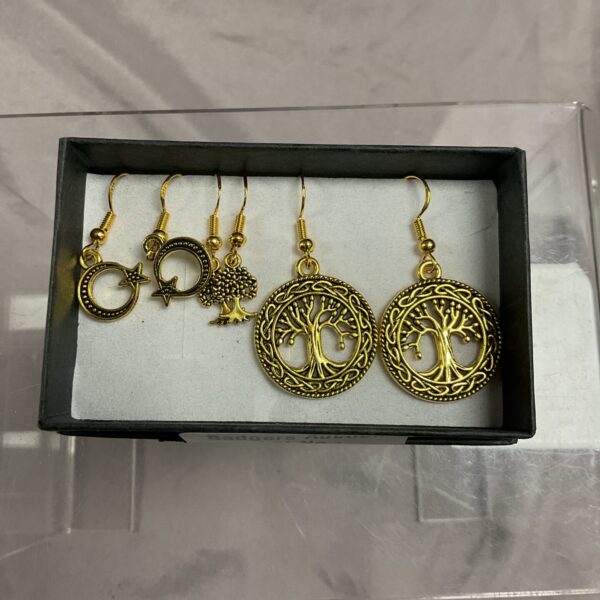 Close-up of three pairs of silver gilt Tree of Life earrings.