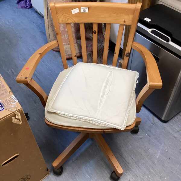 Front view of a vintage pine office swivel chair.