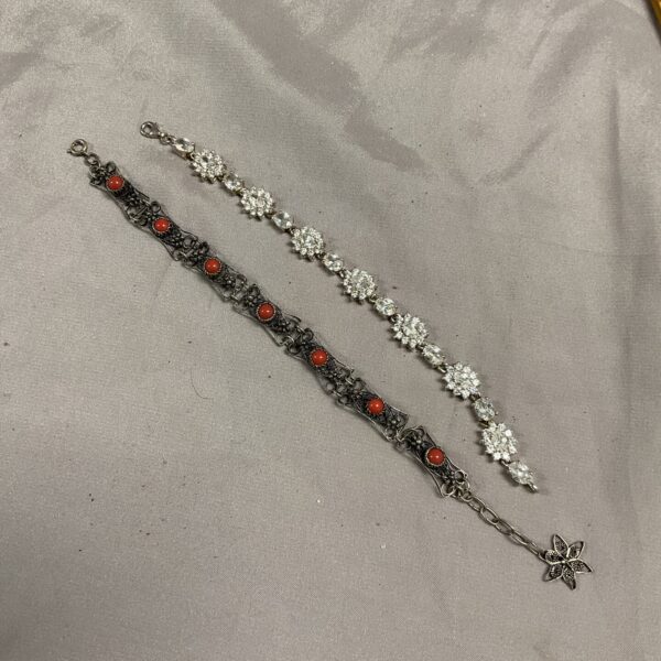 Vintage silver bracelet set with filigree and white stones.