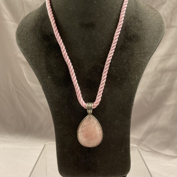 Pink jade pendant necklace with silver setting and rope chain.