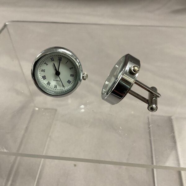 Close-up of digital watch cufflinks, unique men's accessory.