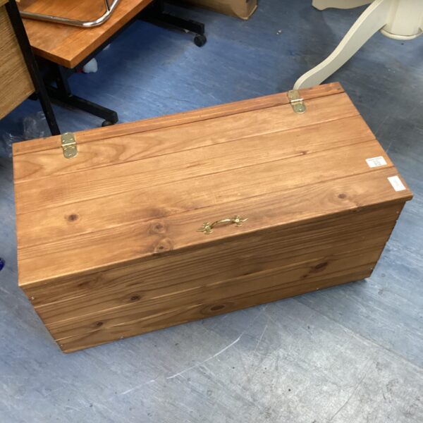 Vintage pine storage trunk with a rustic aesthetic.