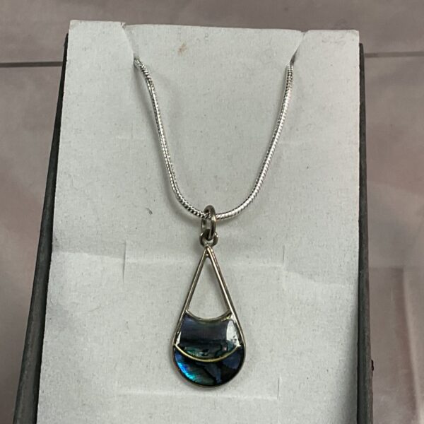 Iridescent silver teardrop pendant necklace on a snakelink chain.