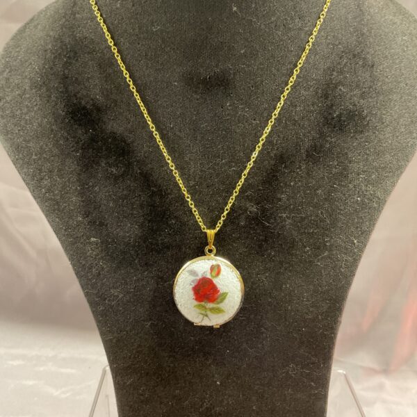 Vintage silver gilt rose locket pendant on a chain.