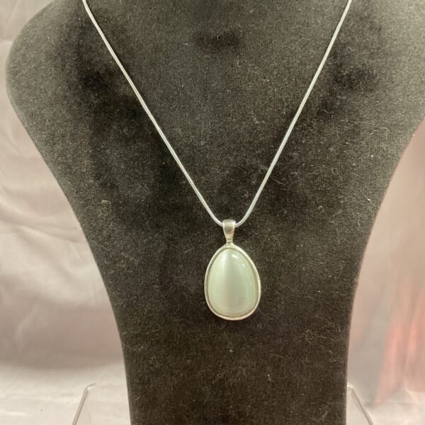 Elegant silver moonstone pendant on a snakelink chain necklace.