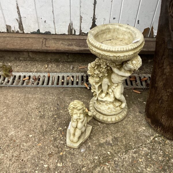 Cherub garden fountain statue with shell detail.