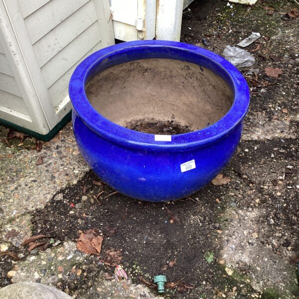Large blue ceramic garden planter for outdoor plants.