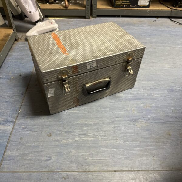 Vintage metal strongbox with handle and lock, side view.