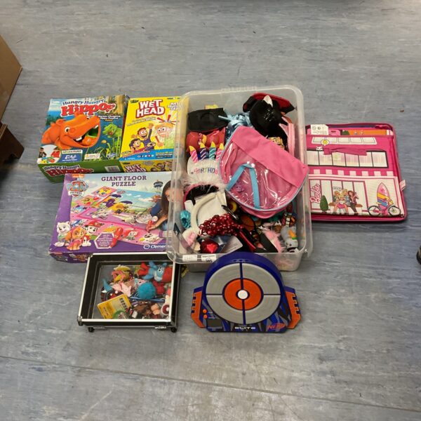 Overview of a mixed toy lot including games and a target.