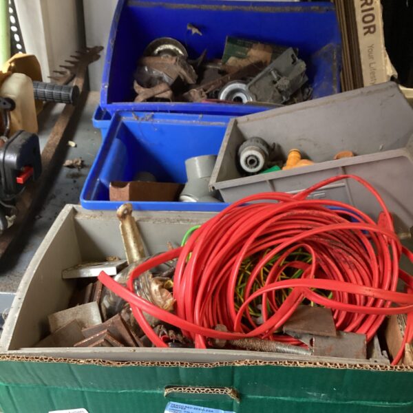 Assorted tools and hardware in a blue storage box.