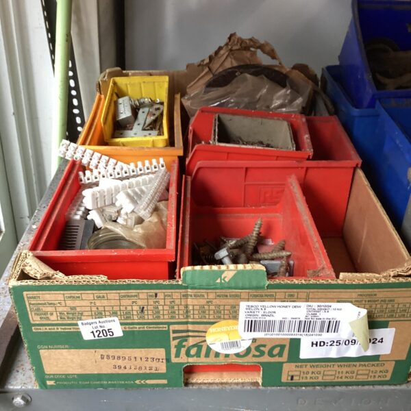 Red container filled with mixed hardware and metal fixings.