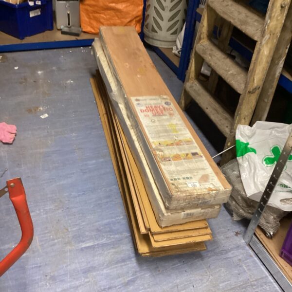 Stack of Floormaster laminate flooring planks for DIY projects.
