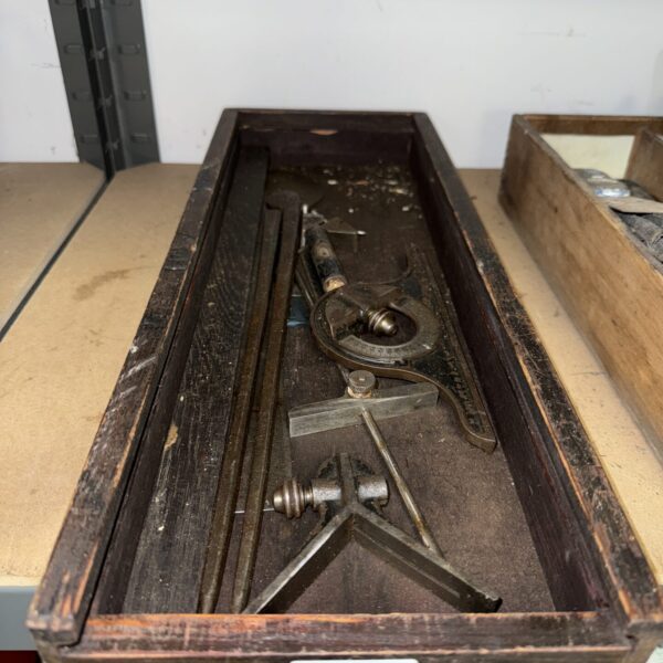 Vintage engineers measures in a wooden box, including calipers and dividers.