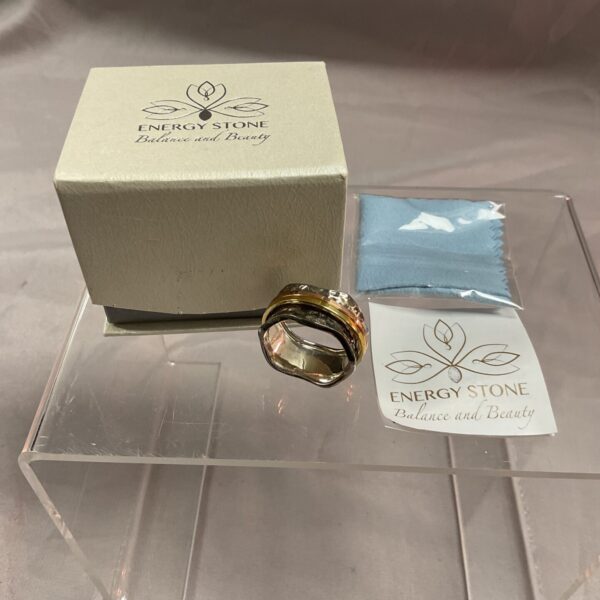 Close-up of sterling silver spinner ring with copper and brass bands.