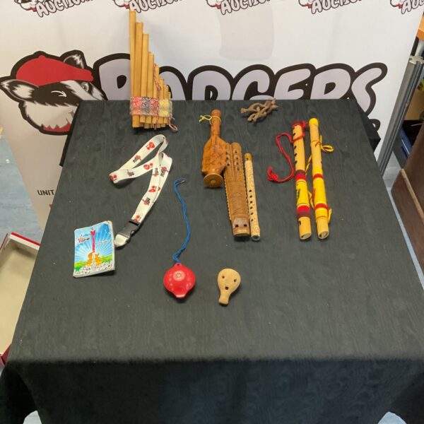 Collection of vintage wooden flutes and whistles on display.