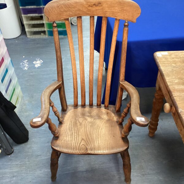 Detailed view of a Victorian armchair's wooden frame and spindles.