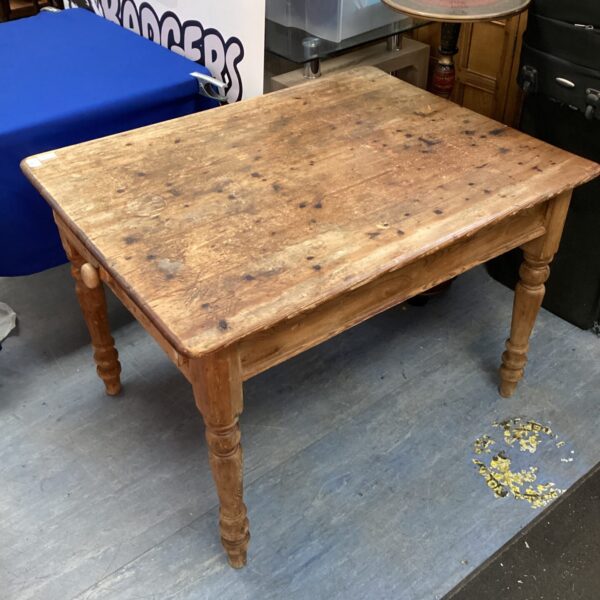 Antique pine kitchen table with turned legs and rustic patina.