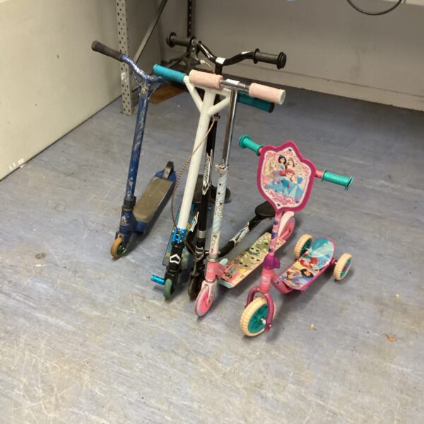 Group of colourful children's scooters for outdoor play.